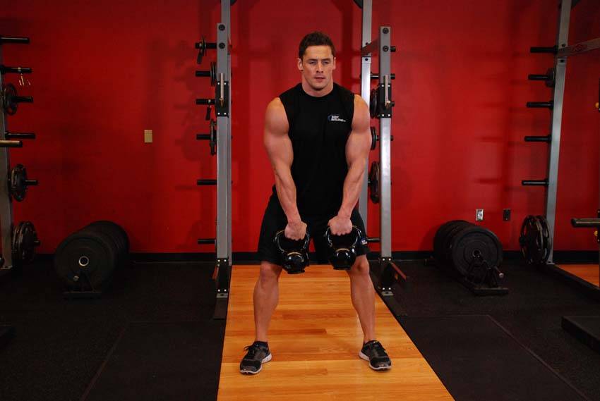 Double Kettlebell Alternating Hang Clean — start position