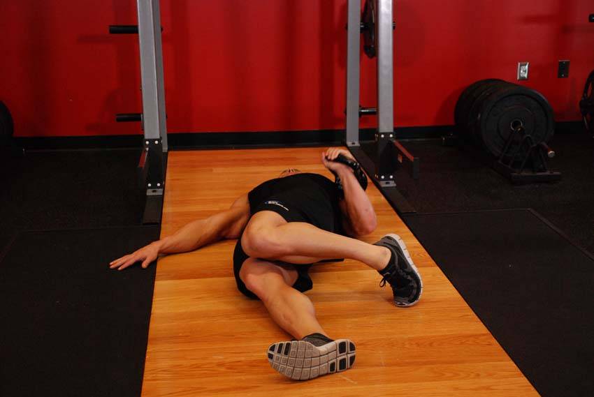 Extended Range One-Arm Kettlebell Floor Press — start position