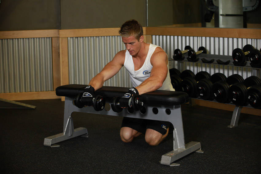 Palms-Down Dumbbell Wrist Curl Over A Bench — start position