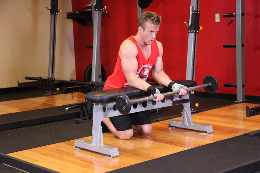 Palms-Up Barbell Wrist Curl Over A Bench — start position