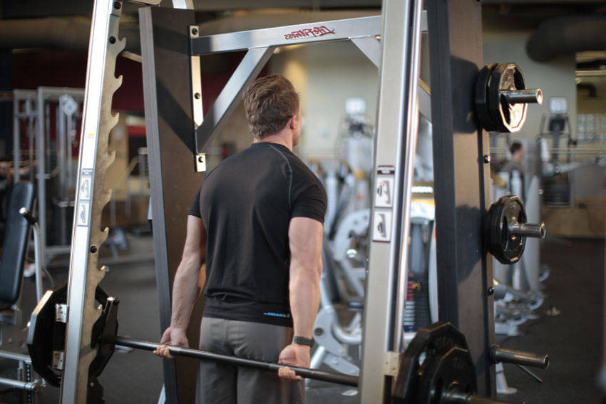 Smith Machine Behind the Back Shrug — start position