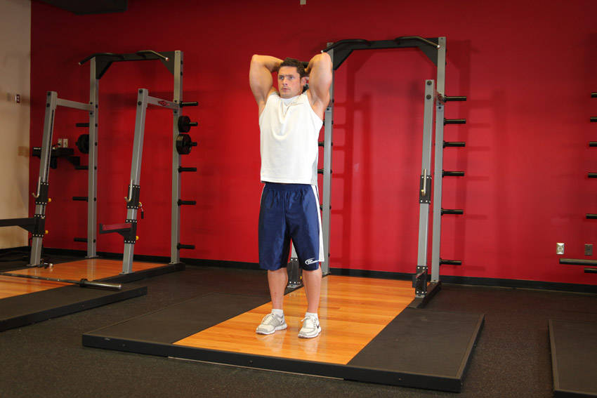 Standing Dumbbell Triceps Extension — end position