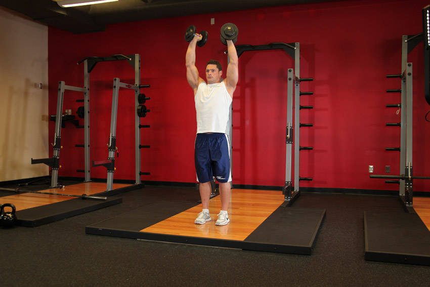 Standing Palms-In Dumbbell Press — start position