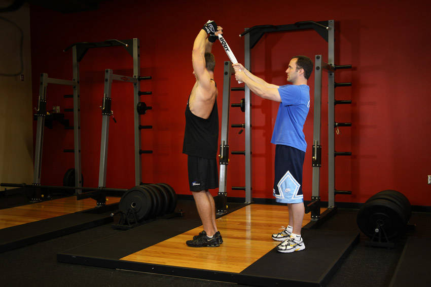 Standing Towel Triceps Extension — end position